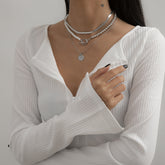 A set of three layered necklaces with a pendant and silver chain, identified as the Pearl & Silver-Plated Toggle Necklace Set.